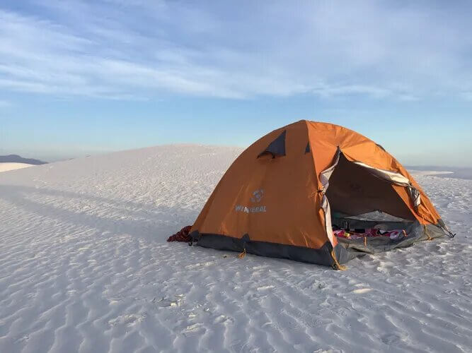 orange tent, white sand, epic location